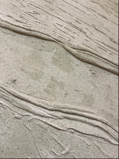 Angled view of Marfil Stone XXL showing organic relief and shadow